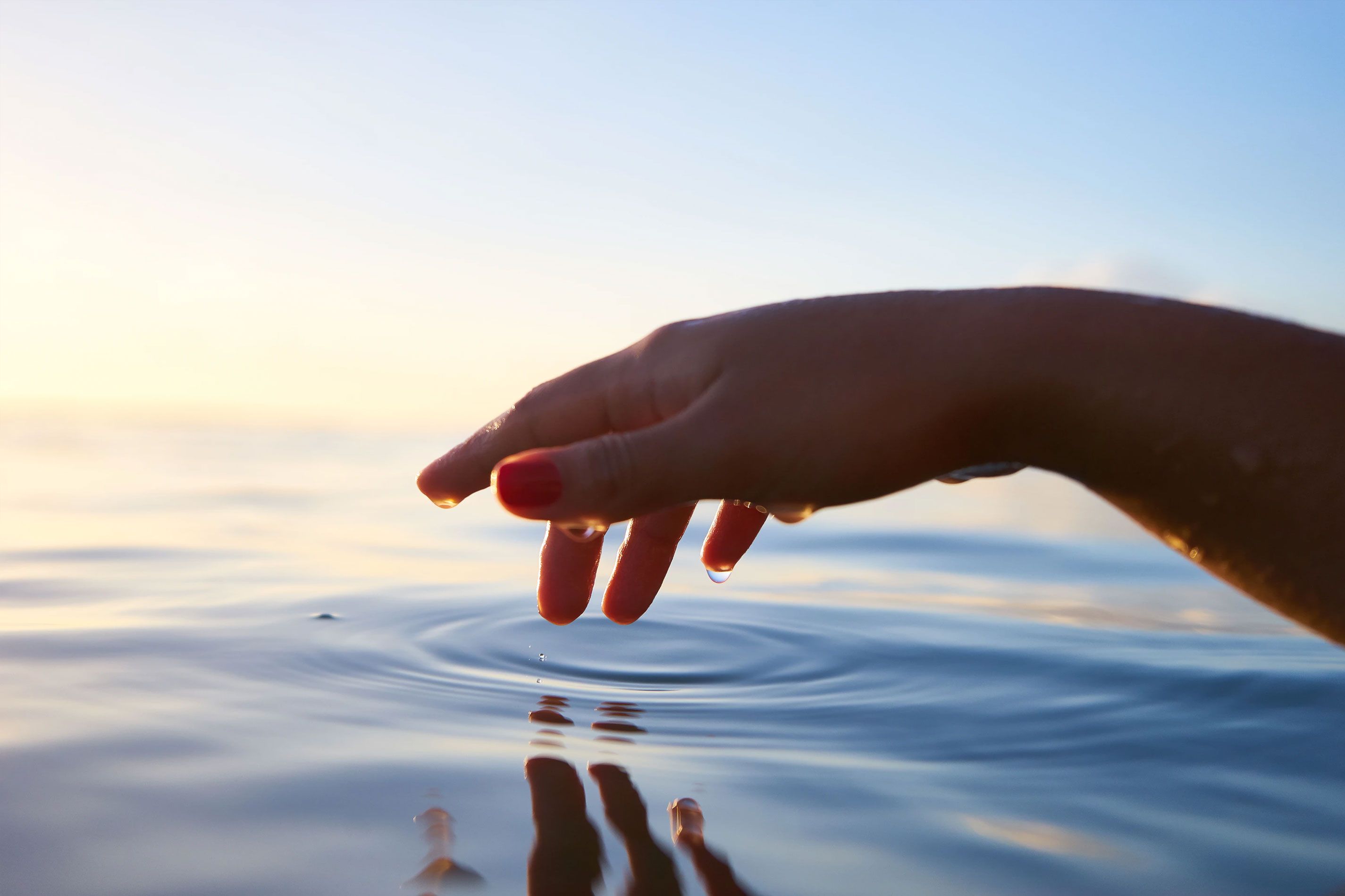 Hand Hovering Above Water Hand Touching Water